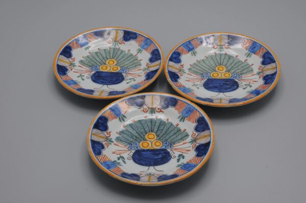 Set of hand-painted miniature polychrome plates with Delft peacock decor, ca 1900