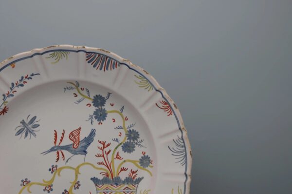 French faience dish with polychrome decoration of a trendy bird, Nevers or La Rochelle, ca 1800