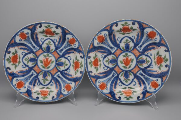 Pair of 18th century polychrome Delft blue, green and orange plates by 'De Paauw'