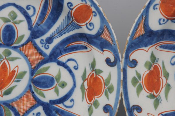 Pair of 18th century polychrome Delft blue, green and orange plates by 'De Paauw'