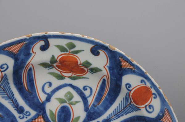 Pair of 18th century polychrome Delft blue, green and orange plates by 'De Paauw'