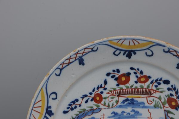 Delft polychrome plate with a cartouche depicting ships - mid 18th century